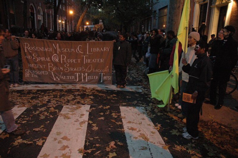 Members of the Rosenbach Museum & Library and Spiral Q Puppet Theatre parade on a Boston Street, featuring Bram Stoker's famous vampire novel, “Dracula.”