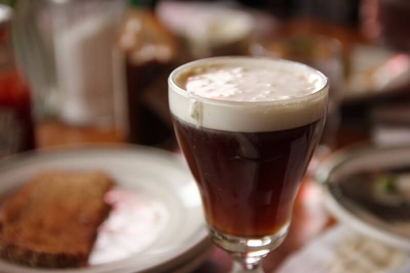 A close-up, focused shot of the Irish Coffee at The Buena Vista in San Francisco, recreated from the original version invented at the Shannon Airport in Ireland