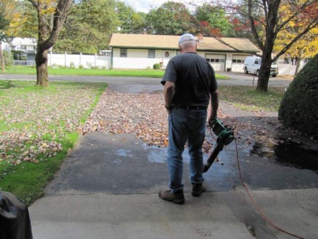 A man using an electric leaf blower