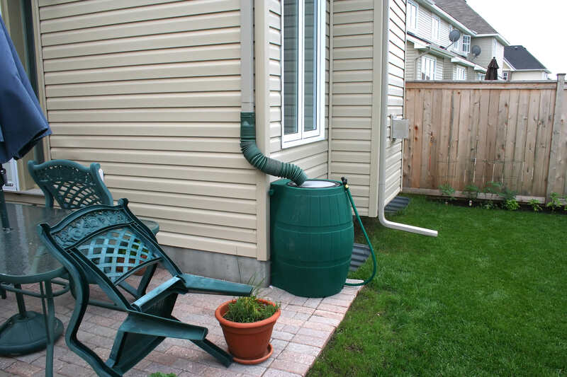 image of a rain barrel in a lawn