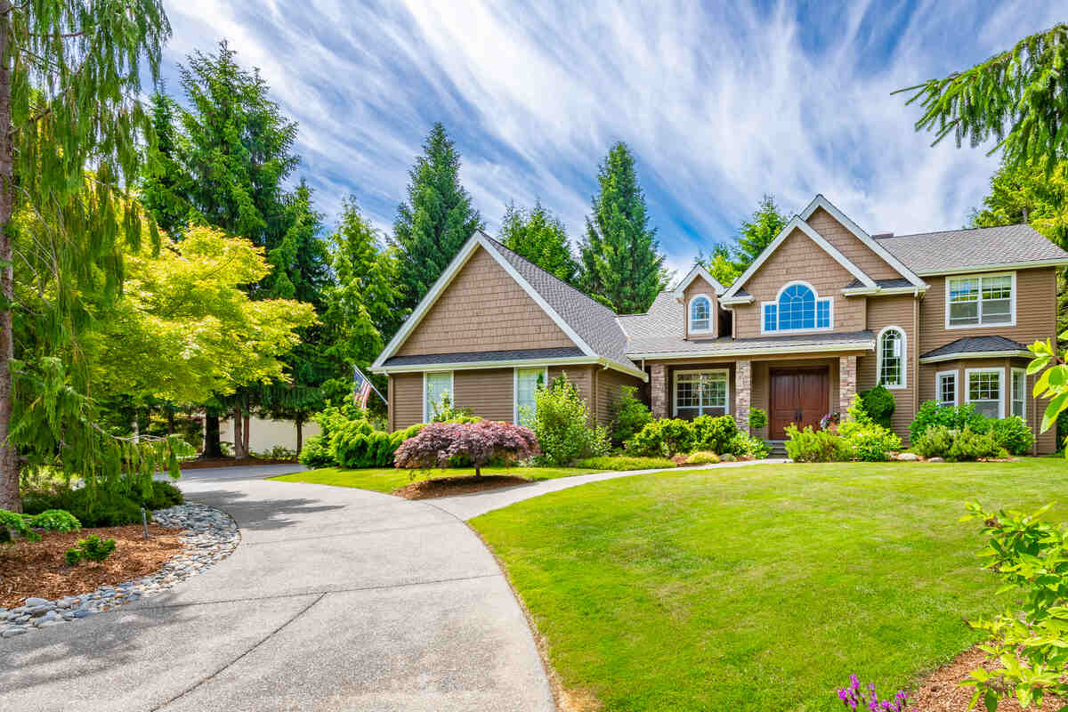 Pacific Northwest Craftsman house on golf course with patio and vibrant sky