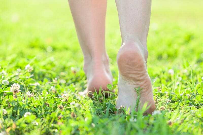 Light step barefoot on the soft summer grass