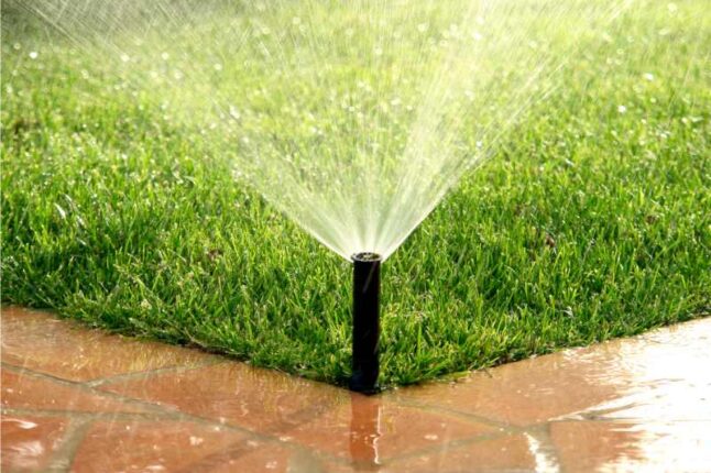 water coming out of a sprinkler system in a lawn
