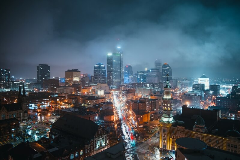 Colorful lights brighten roads and buildings across the skyline of Indianapolis at night