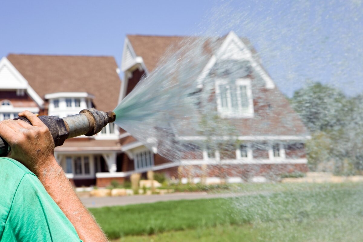 worker hydroseeding a lawn