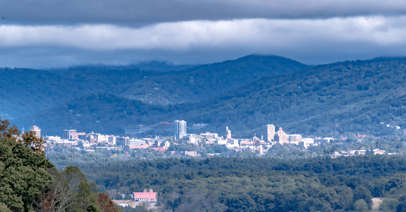 An aerial view of Asheville, North Carolina, surrounded by mountains