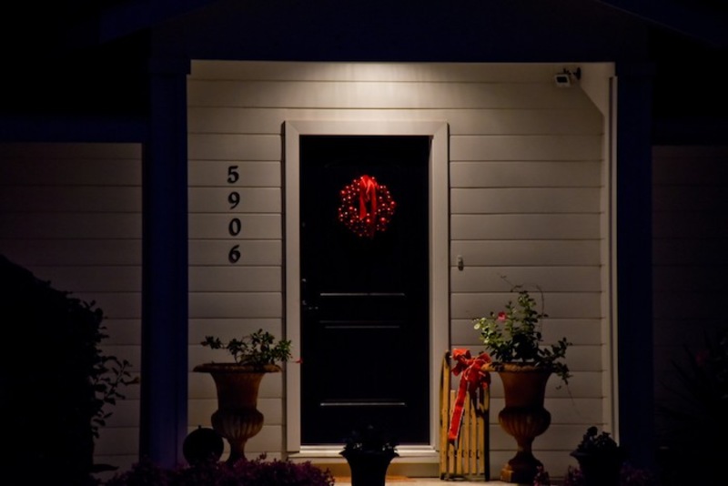 Black front door lit up at night