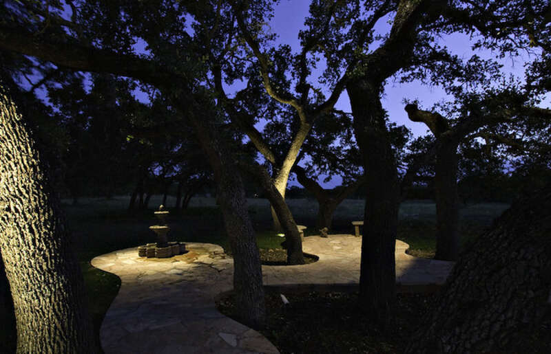 Spotlight shines down on distant landscape feature at night