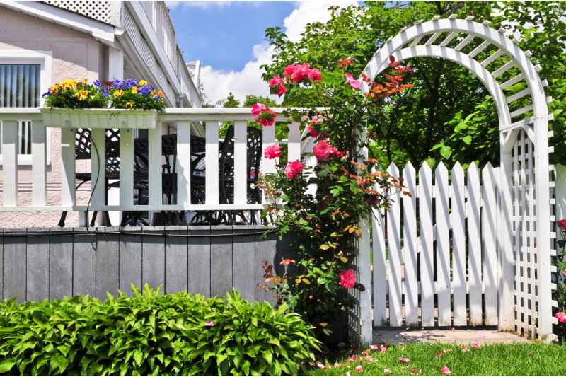 white arbor in a yard