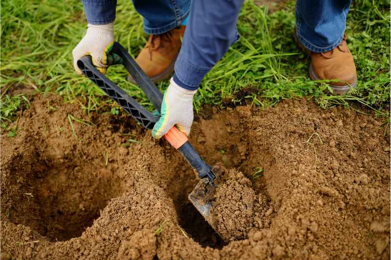 man digging hole with a shovel