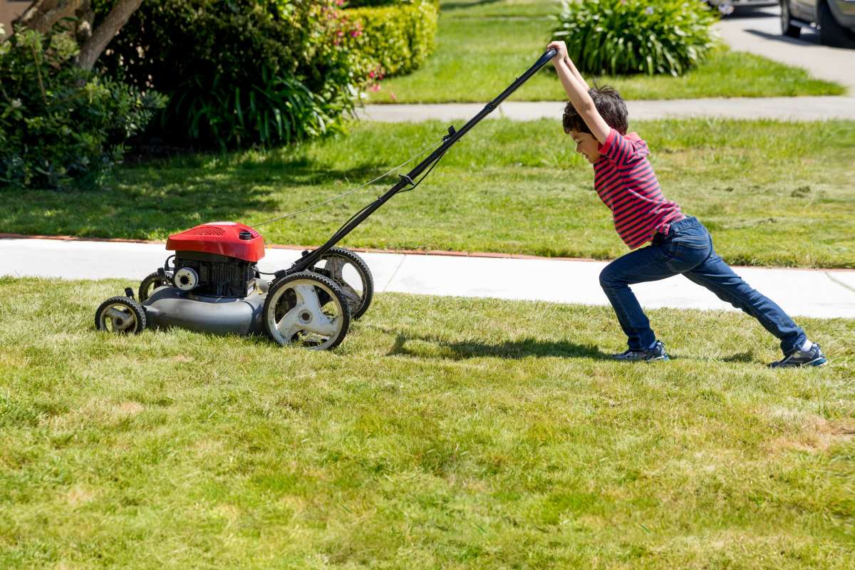 Kid mowing a lawn