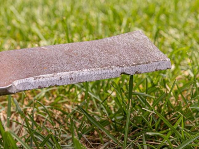 close-up of lawn mower blade that is chipped