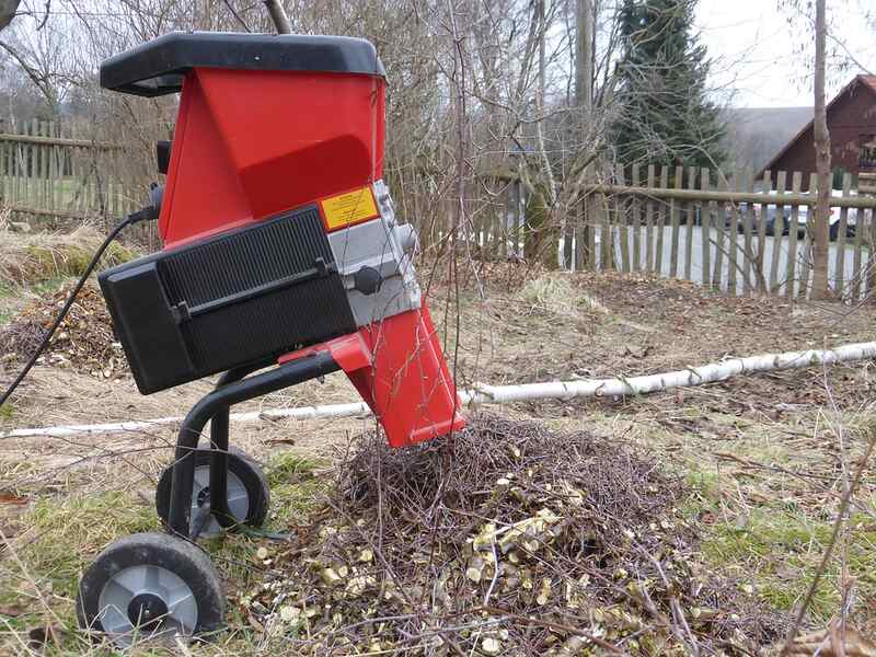 red wood chipper on a yard