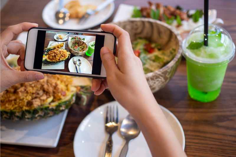 person taking picture of food