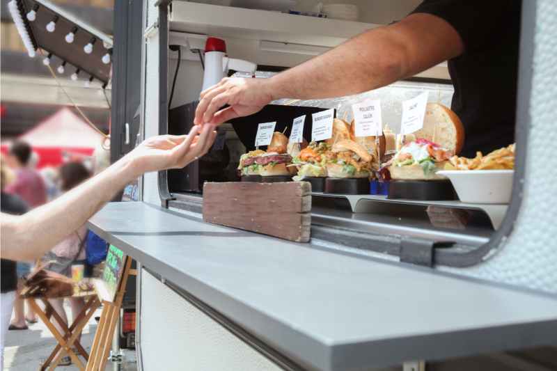 person buying food from a food truck