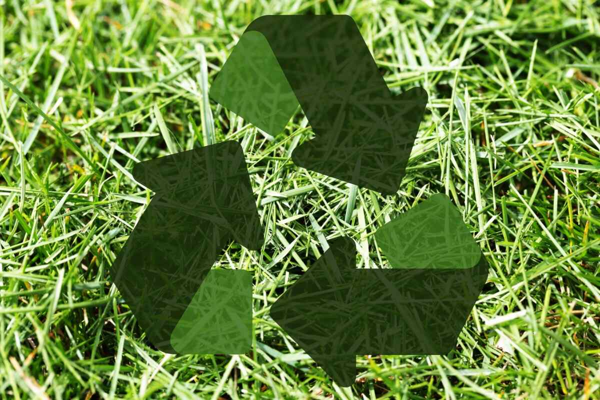 grass clippings with 'recycle' symbol overlay