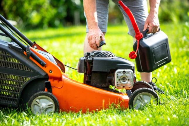 Man refueling lawn mower