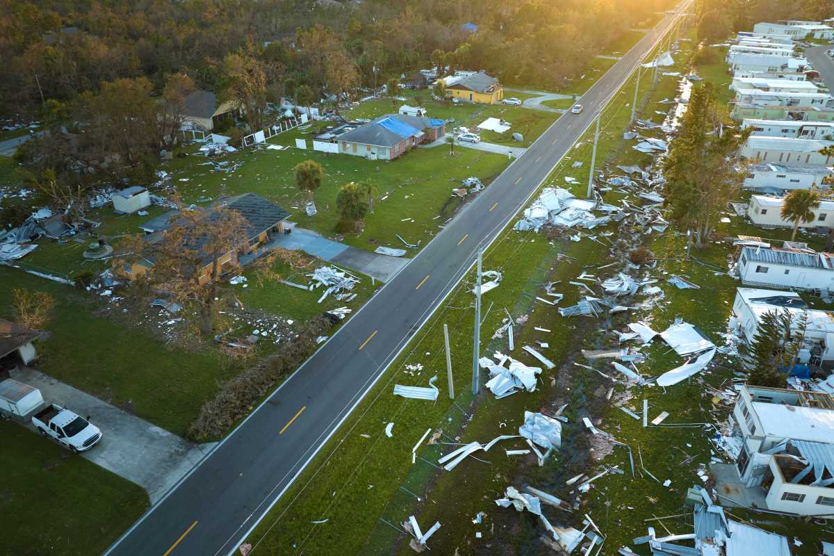 Severely damaged by hurricane Ian houses in Florida mobile home residential area. Consequences of natural disaster.