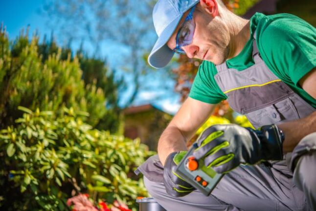 Water Supply Controller in Hand of Professional Garden Technician.