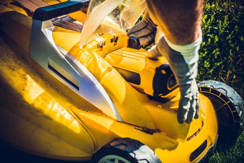 Man replacing lawn mower battery