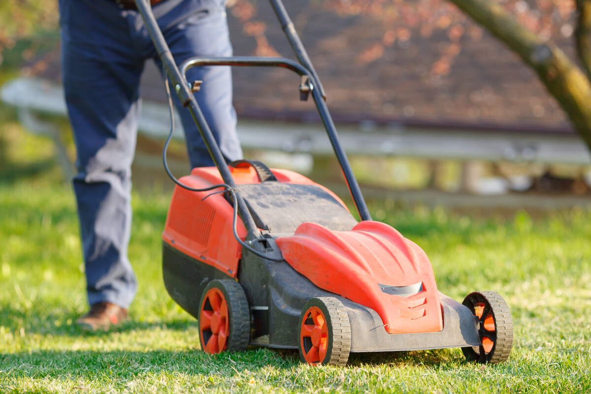 man mows the lawn grass with a lawn mower