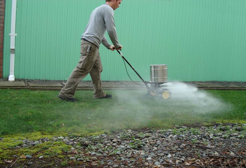 Person spreading lime on a lawn