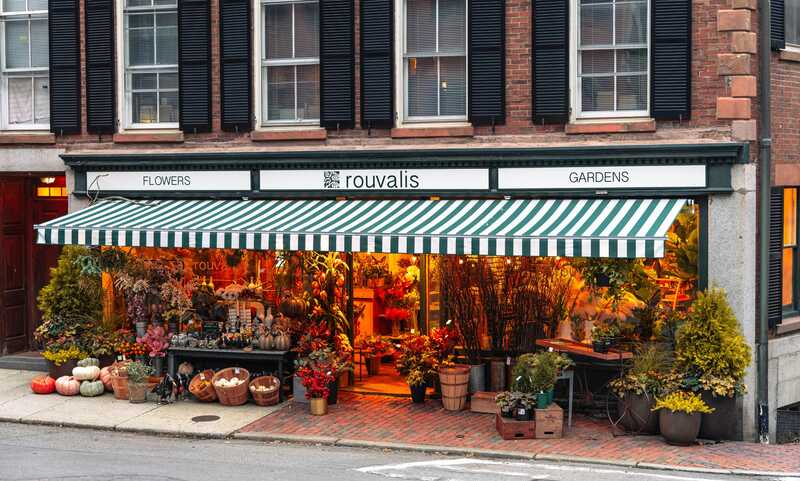 large striped awning above a flower shop