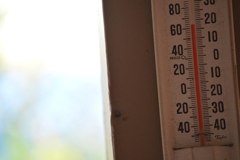 A thermometer displaying around 63 degrees Fahrenheit
