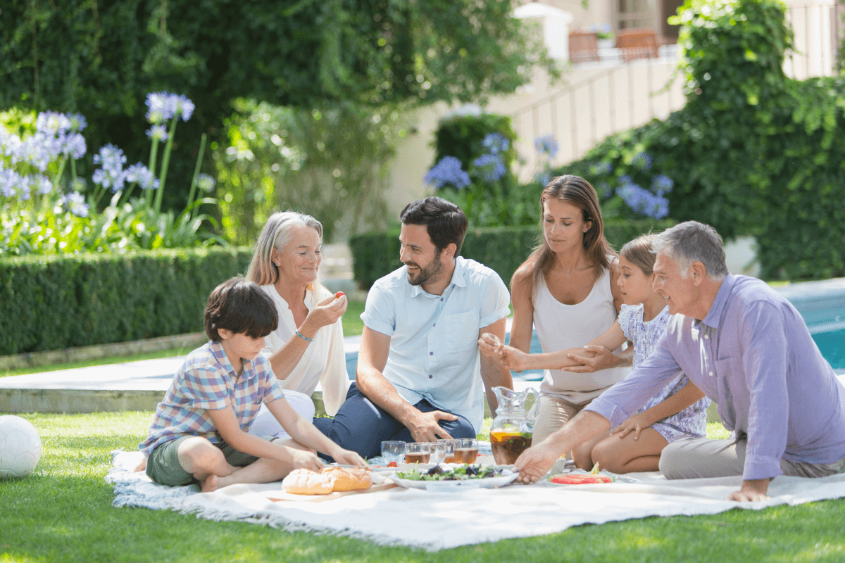 Family enjoy a picnic in a sunny garden