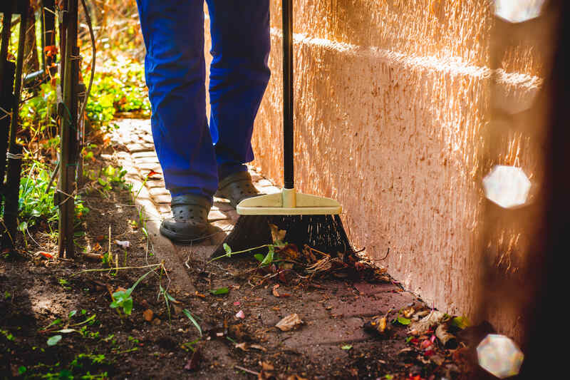 Man cleaning fall leaves