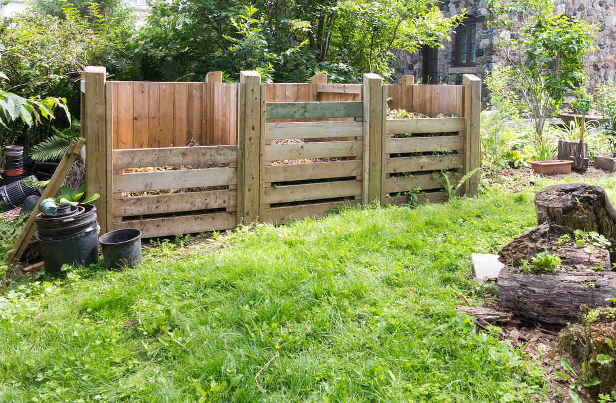 Compost bins in yard made of wood