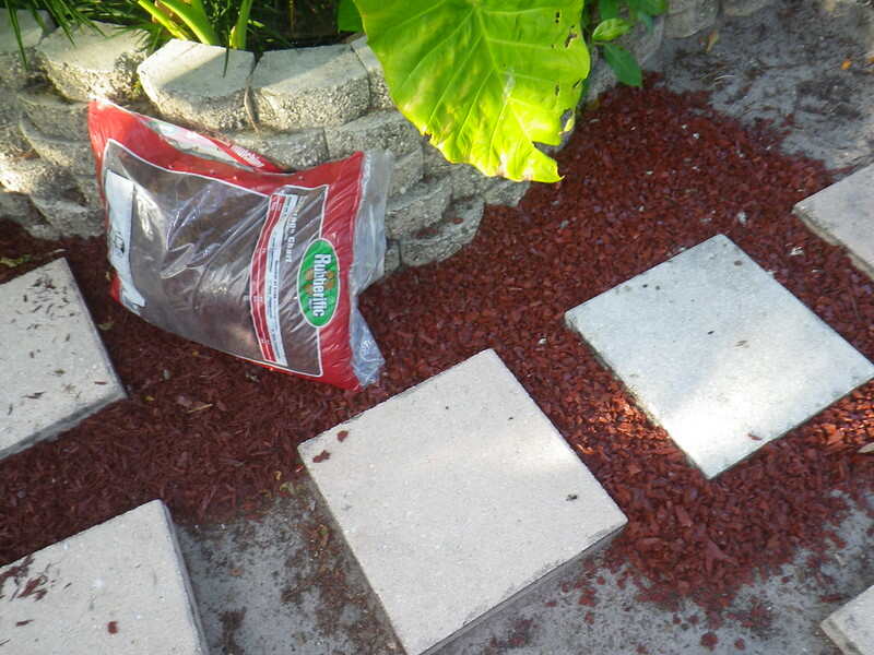 New red mulch being laid around stepping stones