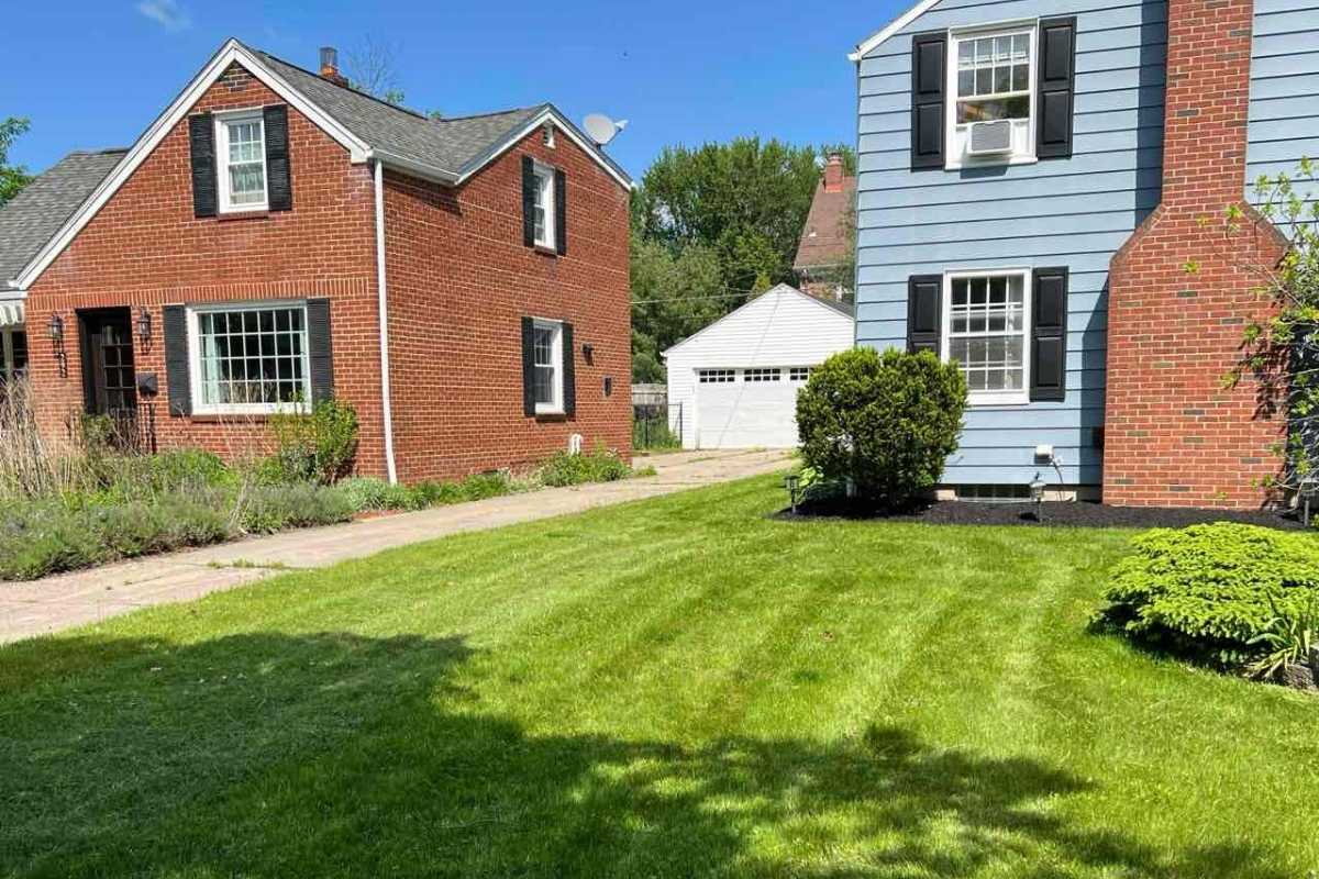 lawn in front of a house in Buffalo with sky in background
