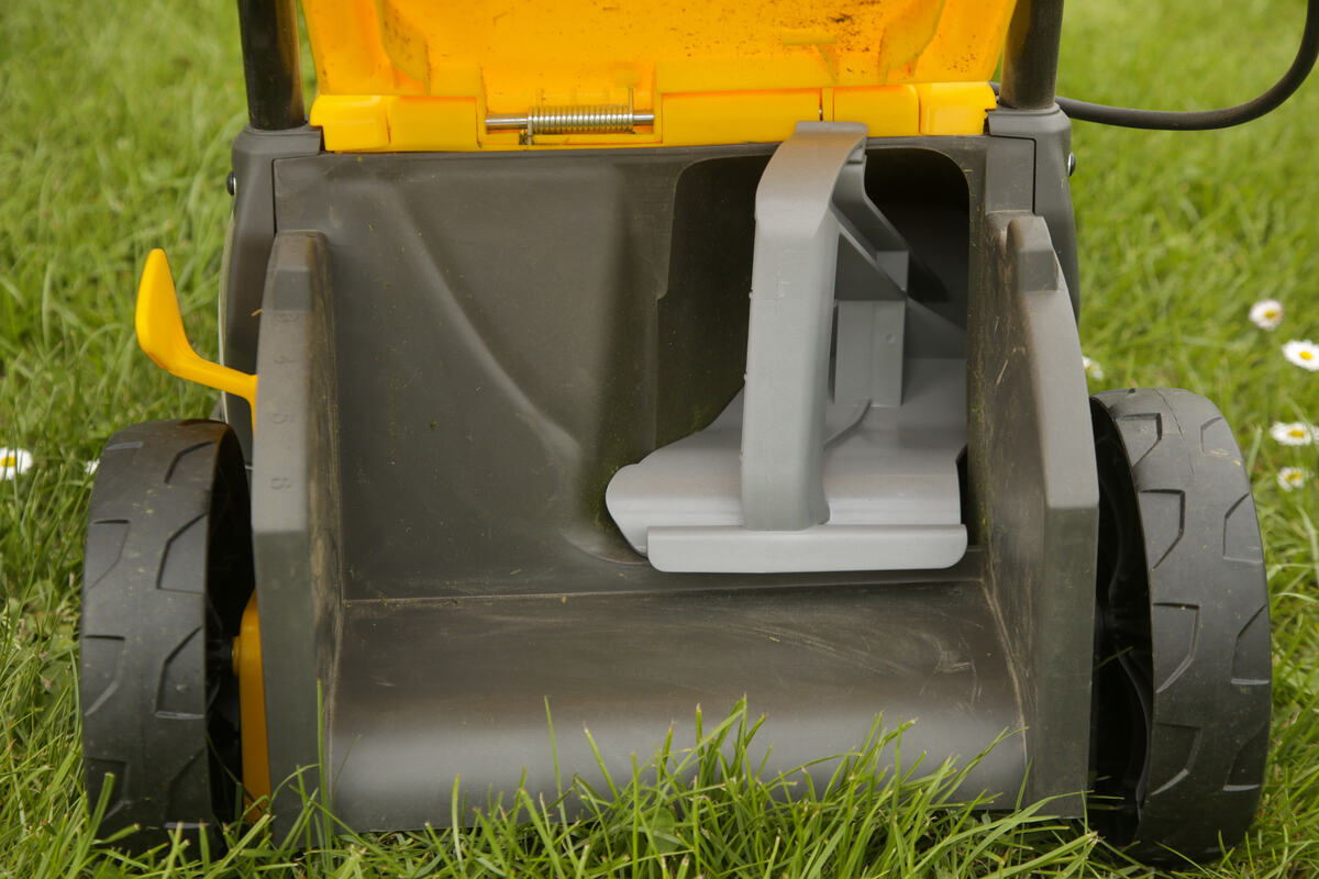 Close up image of lawn mower with inserted mulching plug