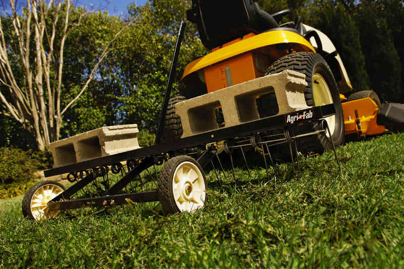 Lawn dethatcher machine on a grassy yard