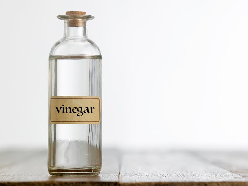 white vinegar bottle on a wooden surface