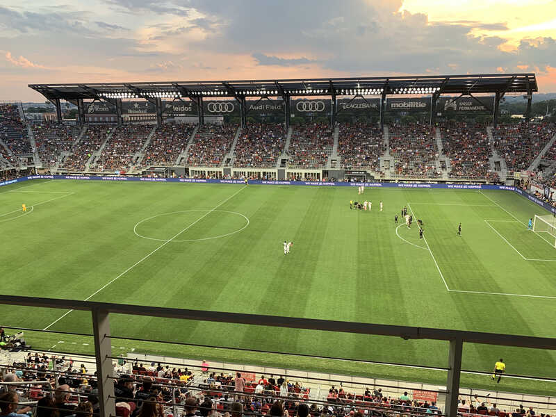Soccer match at sunset in packed Audi Field, home of D.C. United.