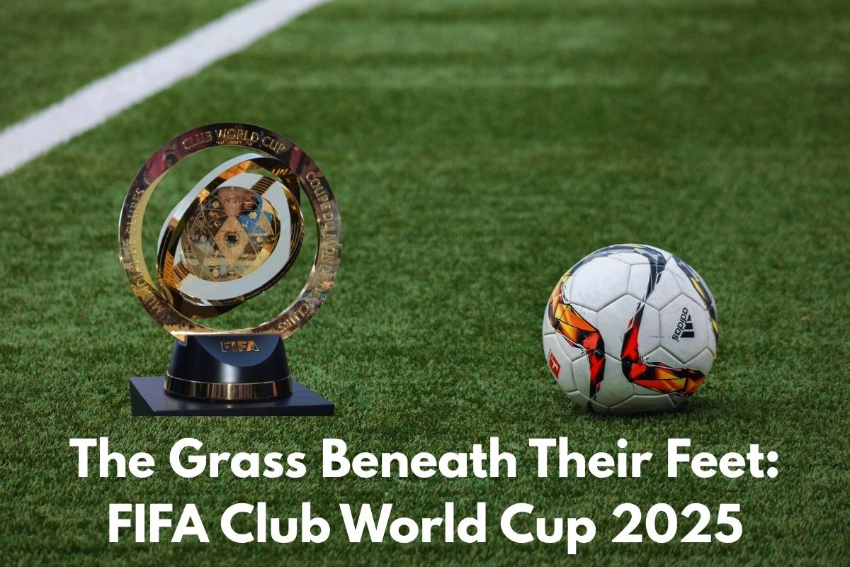 A FIFA Club World Cup trophy and an Adidas soccer ball sit on a lush green stadium field. Bold white text at the bottom reads: “The Grass Beneath Their Feet: FIFA Club World Cup 2025.”