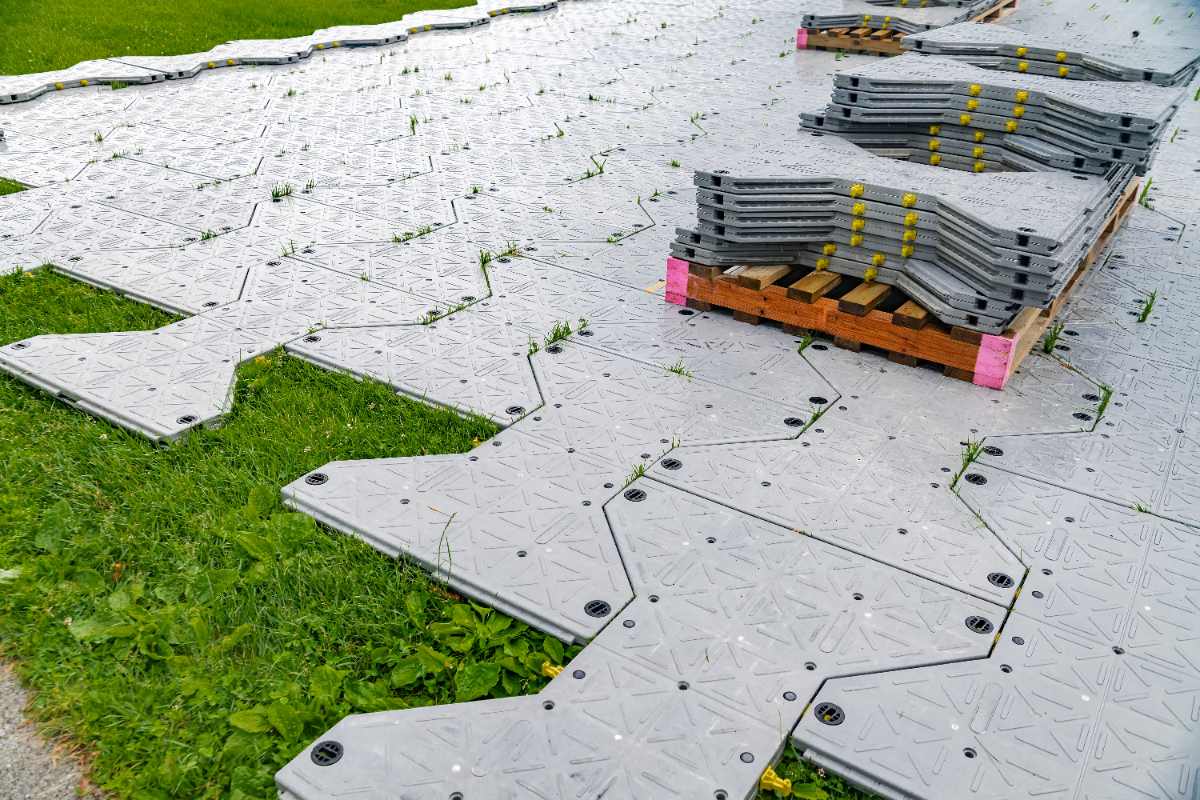 Installation of plastic portable floor to protect the lawn