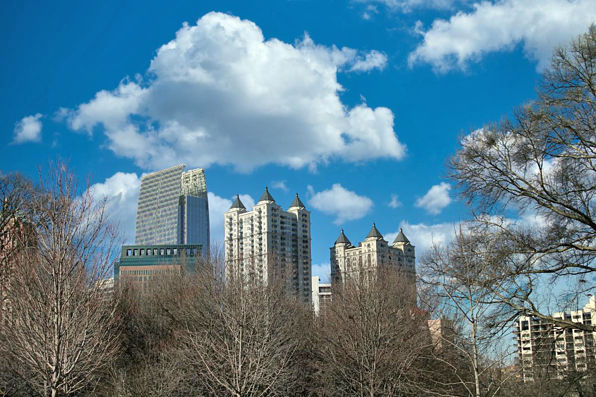 Bare trees surround the skyline of Atlanta in winter.