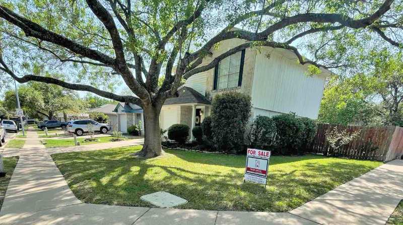 Well-maintained front lawn with neatly mowed grass in front of a house in Austin, Texas.