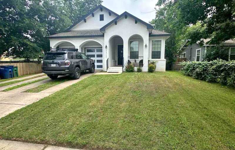 Well-maintained front lawn with neatly mowed grass in front of a house in Austin, Texas.