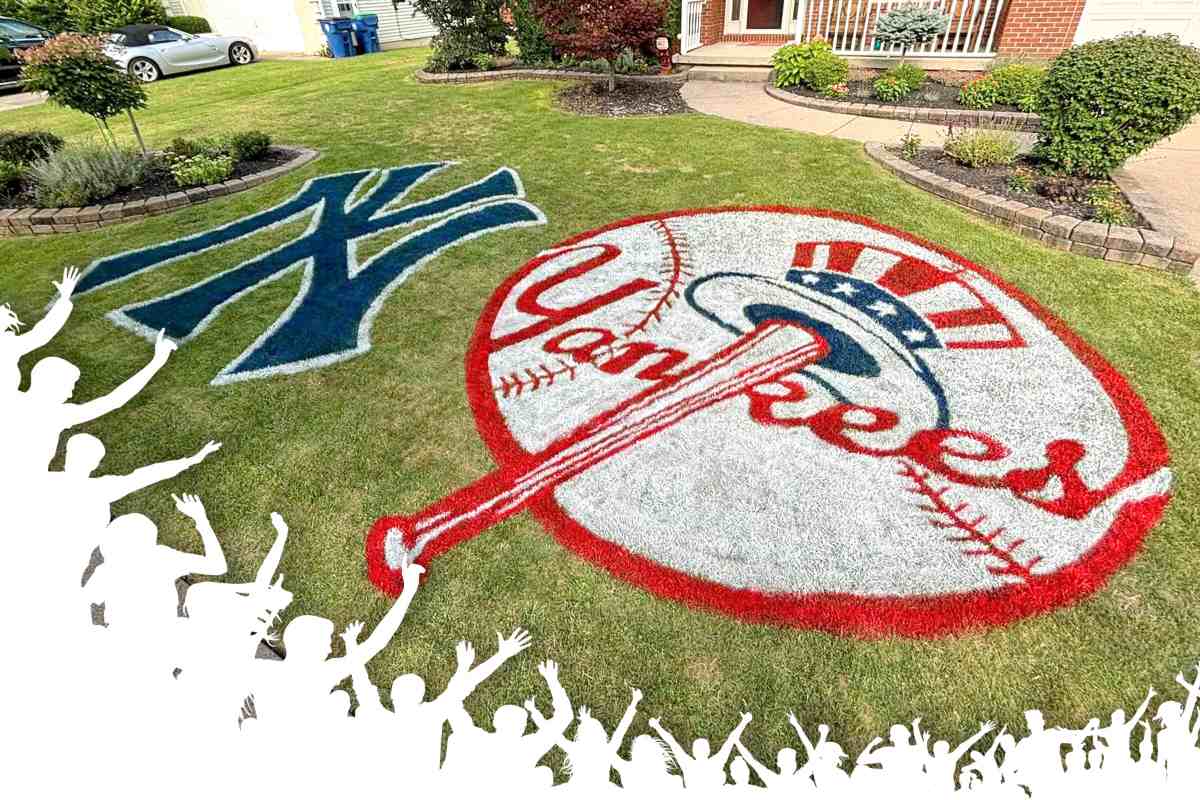 An illustration of fans cheering lines the bottom of an image of New York Yankees lawn art in front of a brick home.