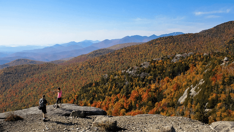 Yellow, orange, red, and green trees paint the mountainous landscape of the Adirondack Mountains in New York State