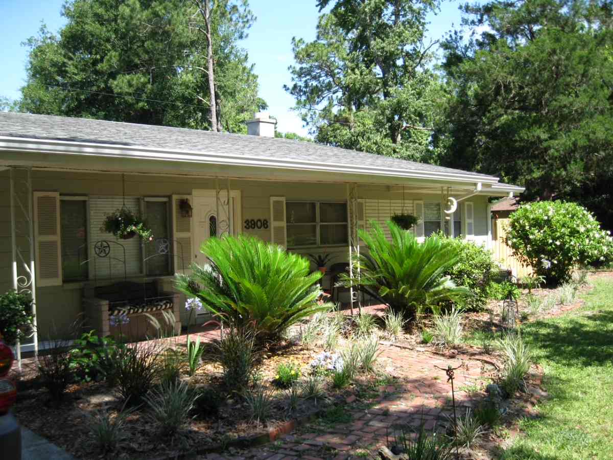 Florida home with landscaped front yard and brick pathway