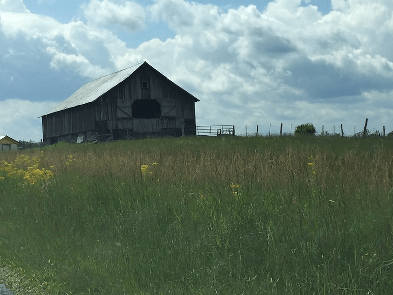 A barn sits on a farm in West Virginia on a sunny day