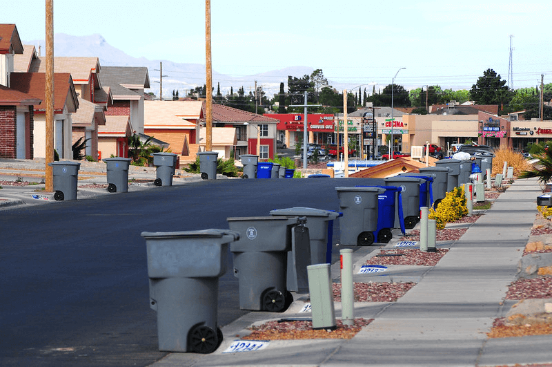 A line of trash bins in a neighborhood in El Paso, Texas