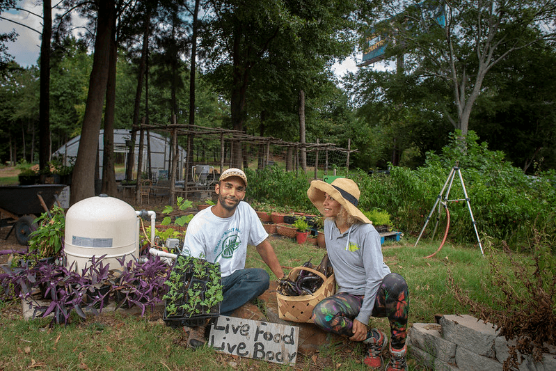 Two urban farmers show off their harvest in Atlanta