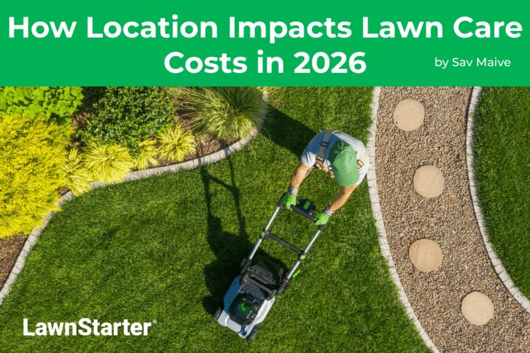 A lawn care pro mows a lawn between hardscaping