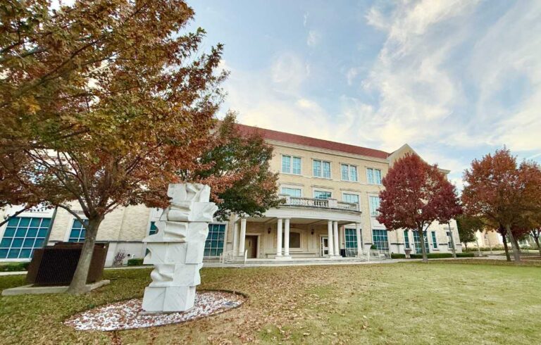 Fall lawn outside a Fort Worth campus building with autumn trees, green grass, and seasonal landscaping inspiration for homeowners.